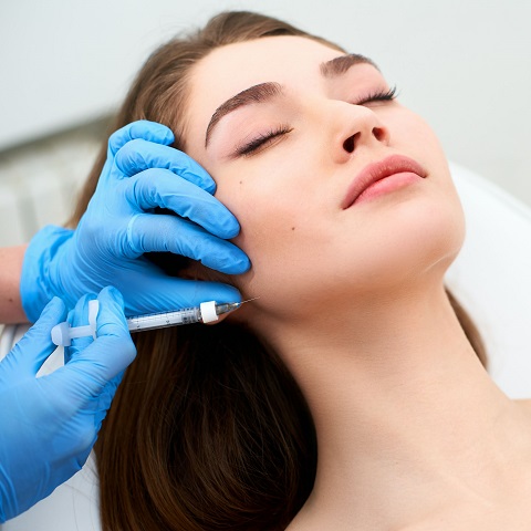 Woman getting cosmetic injection of botox on cheeks. Woman in Clinic | Vita Aesthetics in Sarasota, FL